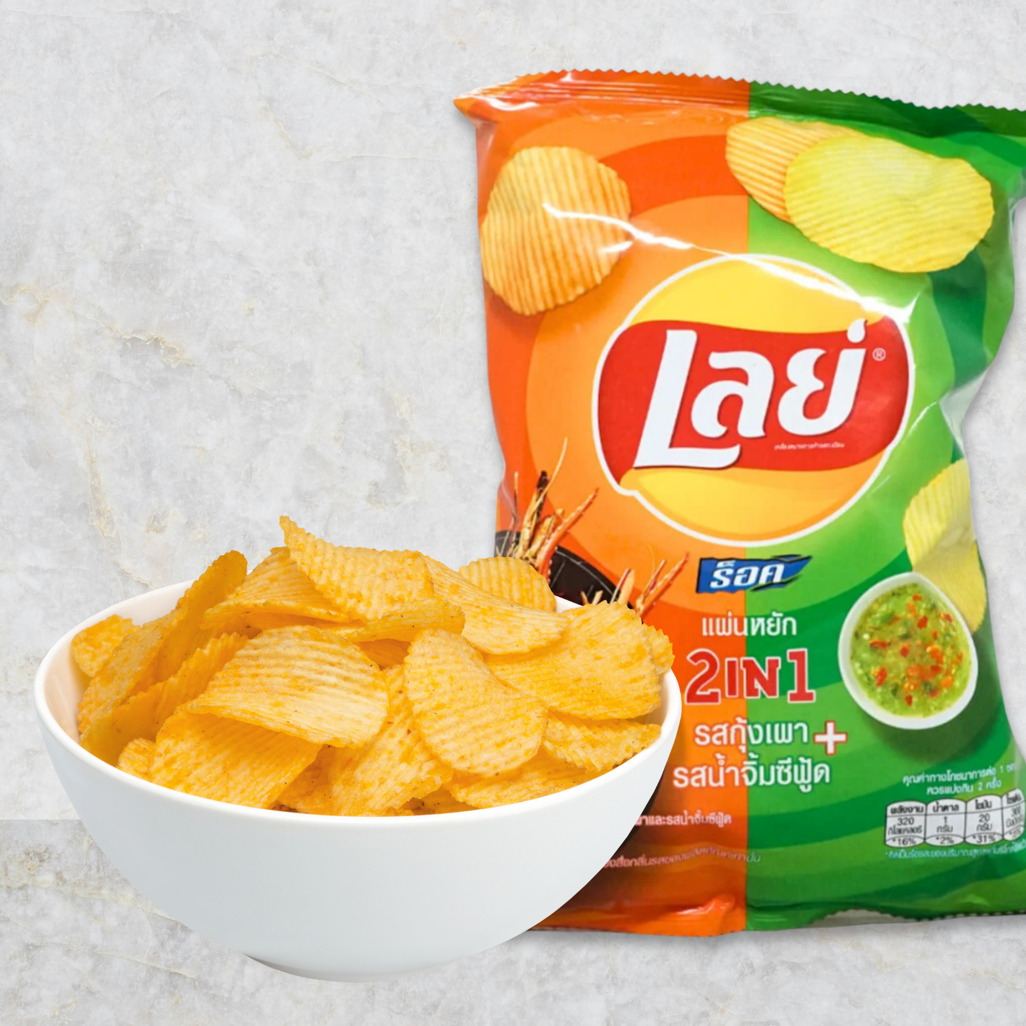 A white bowl filled with ridged chips is in front of a 2-in-1 grilled shrimp and seafood Asian potato chip bag.