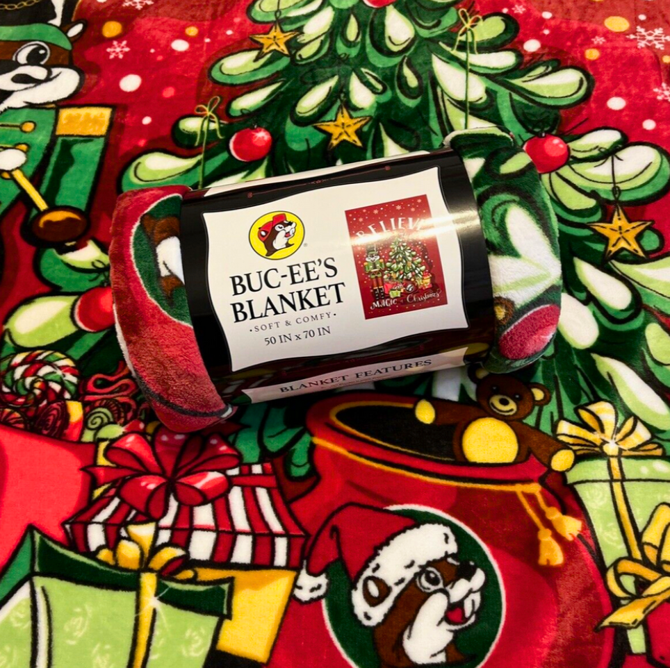 Buc-ee's Christmas blanket rolled up with festive nutcracker and Christmas tree design.