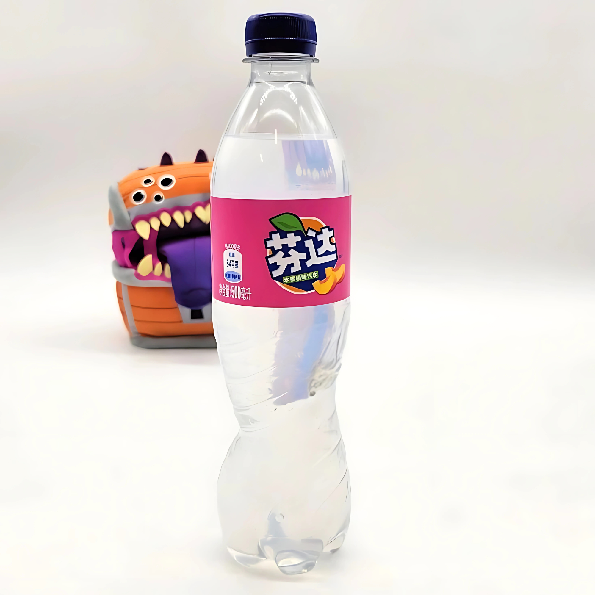 Clear White Peach Fanta bottle on white background with fun, colorful backpack in the distance.