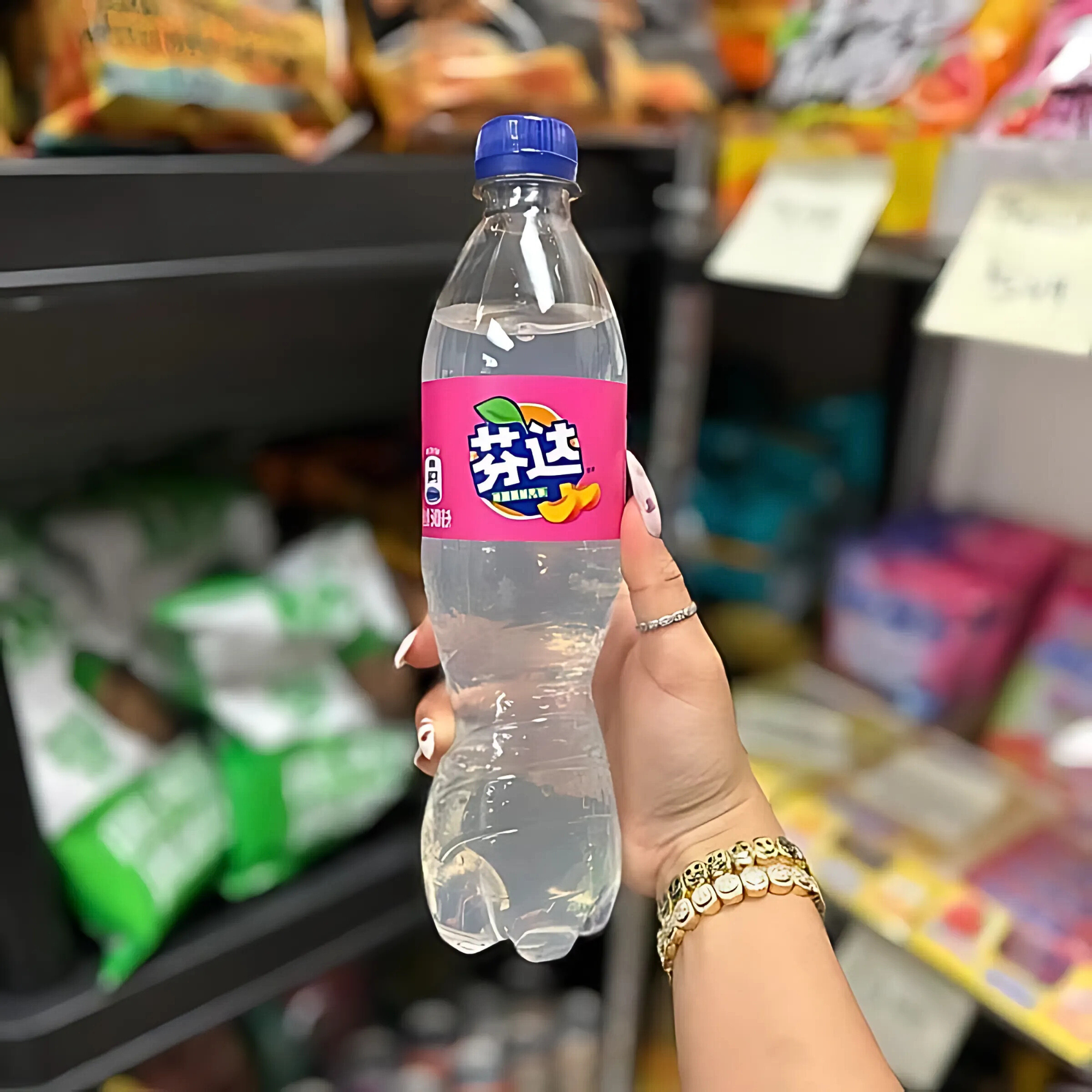 White Peach Fanta held in hand at an Asian snack shop, showing label close-up.