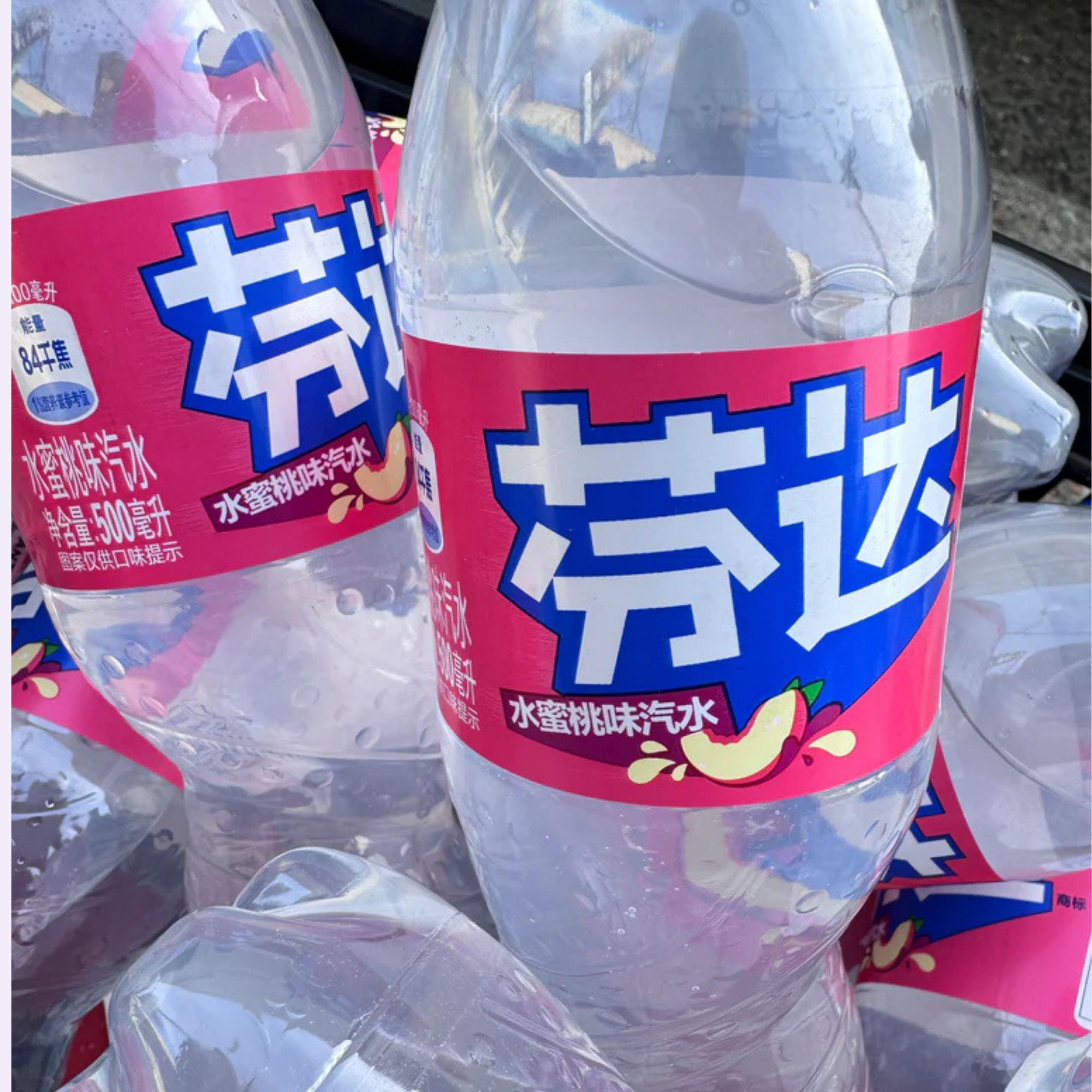 Group of White Peach Fanta bottles showing Taiwanese label and peach logo.