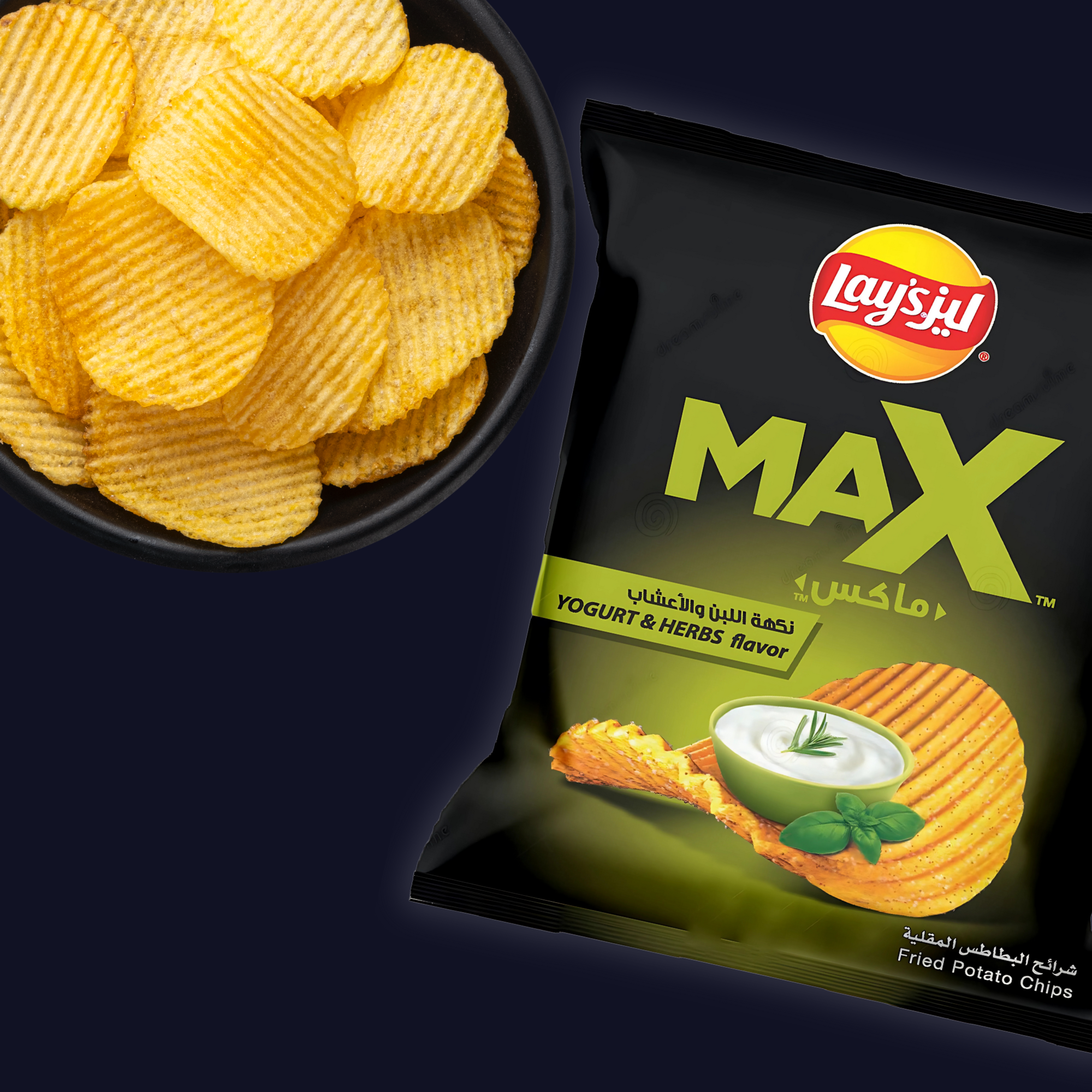 Close-up of ridged potato chips in a black bowl next to the Lay’s Max Yogurt & Herbs flavor bag on a dark background.