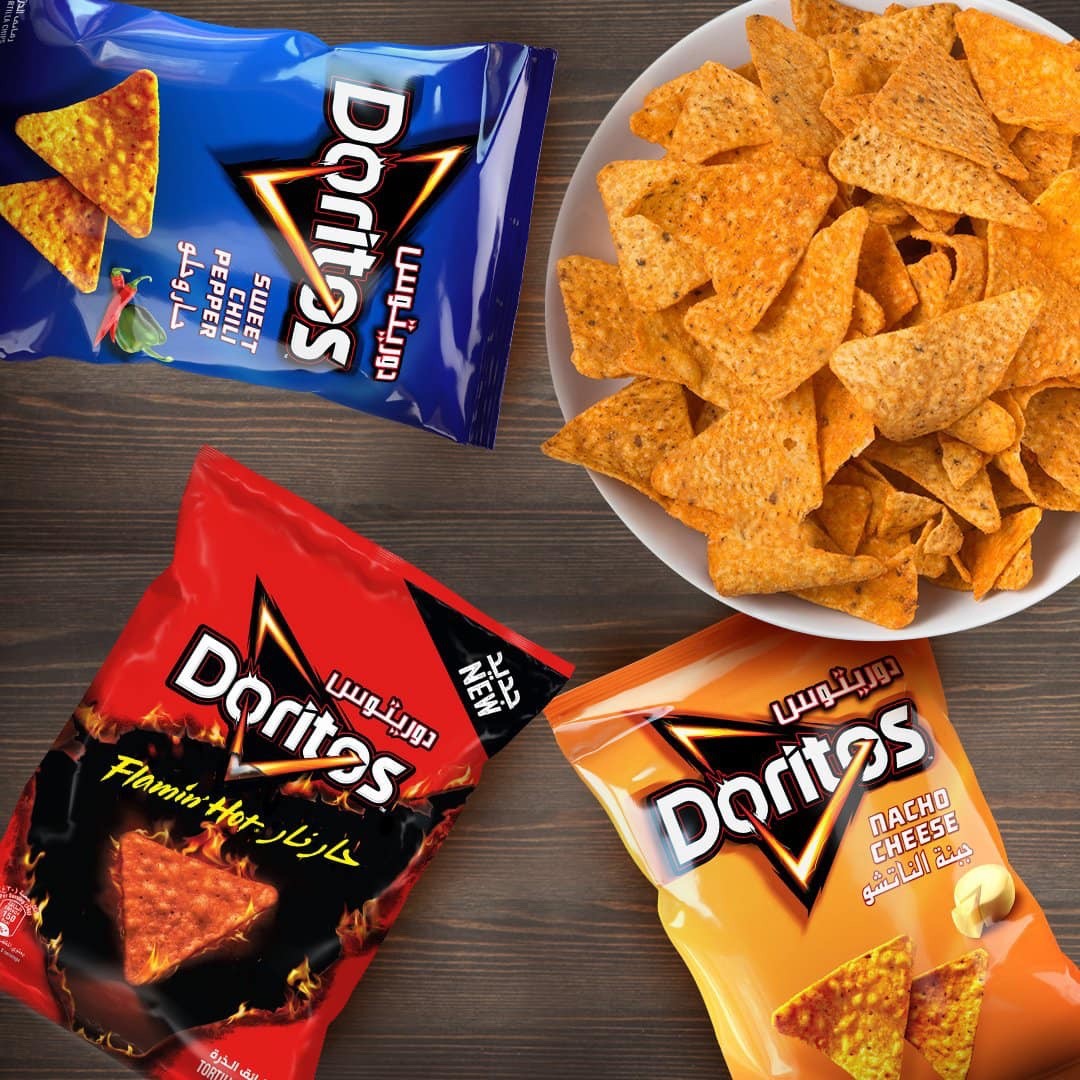 Doritos Sweet Chili Pepper chips from Iraq shown with other Doritos flavors and a bowl of tortilla chips