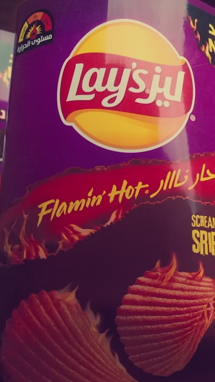 Video featuring people trying Doritos Screamin’ Sriracha tortilla chips and reacting to the intense spicy flavor