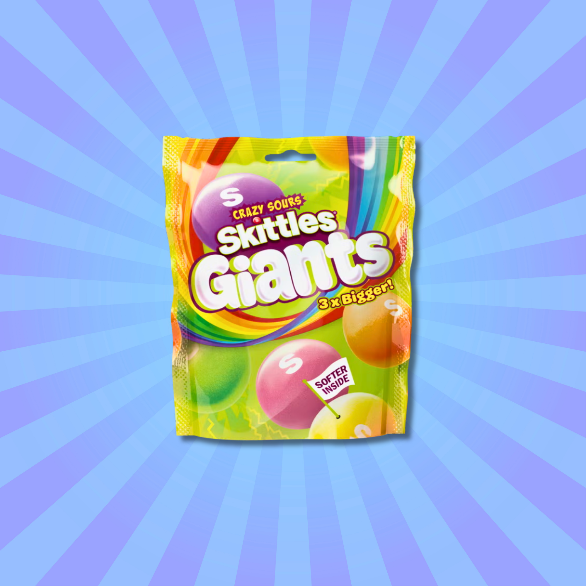 A bag of Skittles Crazy Sour Giants from The UK on a blue starburst background. The colorful bag highlights "3x Bigger" and "Softer Inside" with vibrant graphics. Available to buy online.
