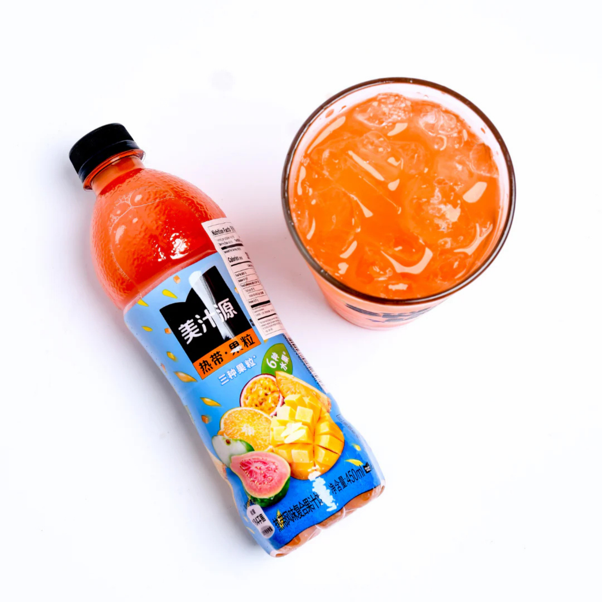 Shop Tropical Punch Minute Maid online with passion fruit, mango and guava,  next to a glass filled with the iced juice.